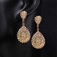 Material: Rhinestone Style: Simple Alloy Earrings With Rhinestones For Party, Party Alloy Crystal Drop Earrings, Alloy Crystal Drop Earrings For Party, Metal Drop Crystal Earrings For Party, Gold Crystal Earrings With Jewels, Party Jeweled Alloy Jewelry, Jeweled Crystal Dangle Earrings, Crystal Jewel Drop Earrings, Teardrop Crystal Jewelry With Rhinestones