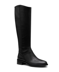 Meet our first-ever tall boot—an elegant reimagining of our best-selling smoking slipper for winter’s colder months. Crafted from premium black leather with a faux stretch leather back, it offers a sleek fit that stretches comfortably to fit most, including wider, calf sizes with ease. This equestrian-inspired riding boot features a stunning tuxedo grosgrain back tab spine that molds to your leg, and the slightly curved topline offers a slimming effect. The footbed includes our signature 7 layer Classic Tall Black Boots, Classic Tall Boots, Classic Leather Sole Knee-high Boots For Winter, Classic Knee-high Boots With Leather Sole For Winter, Classic Winter Knee-high Boots With Leather Sole, Classic Tall Winter Boots, Flat Winter Boots, Winter Boots Black, Black Riding Boots