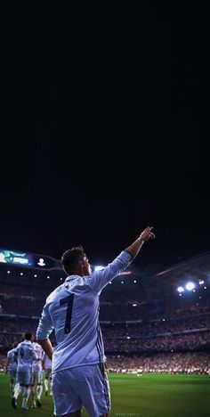 a soccer player with his arms in the air