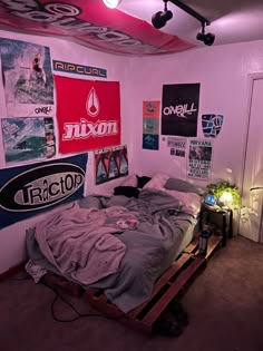 a bedroom with posters on the wall and a bed made out of pallet wood