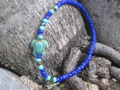 Adjustable Blue Strand Jewelry, Blue Flexible Jewelry For The Beach, Blue Spacer Beads Jewelry For The Beach, Flexible Blue Jewelry For Beach, Single Strand Beaded Bracelets With Round Beads For Beach, Adjustable Polished Beads Bracelets For Beach, Adjustable Polished Bead Bracelets For Beach, Adjustable Polished Beads Bracelet For Beach, Blue Hand-strung Jewelry For Summer