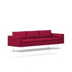 a red couch sitting on top of a white floor