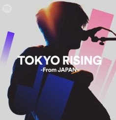 the silhouette of a man holding a laptop in front of a screen with tokyo rising written on it