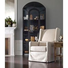 a living room with a chair and book shelf