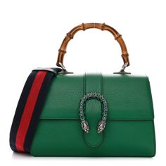 This is an authentic GUCCI Dollar Calfskin Crystal Web Medium Dionysus Bamboo Top Handle Bag in Emerald. This exquisite bag is crafted of textured calfskin leather. The bag has a sturdy bamboo top handle, an optional webbed nylon shoulder strap and a prominent crystal-embellished tiger head horseshoe closure. The flap opens to reveal a natural fabric partitioned interior with patch pockets and a central dividing zipper compartment. Gucci Calf Leather Shoulder Bag, Gucci Calf Leather Satchel Shoulder Bag, Gucci Calf Leather Shopping Bag, Gucci Calf Leather Bags With Gold-tone Hardware, Gucci Evening Bag In Calf Leather, Gucci Leather Top Handle Shoulder Bag, Gucci Calf Leather Evening Bag, Gucci Evening Calf Leather Bag, Gucci Textured Leather Bags