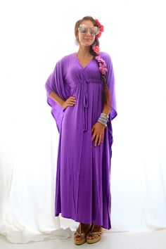 "Summer travel is a breeze when your go-to dress is a maxi kaftan in super soft, rayon jersey knit fabric. Add metallic sandals and sparkly jewelry to get glam in a snap, or try it with earthy accessories for the perfect bohemian summer look. Subtle side slits from the knee down, keep movement in this kaftan easy and the fabric flowing. Available in a rainbow of colors. Shown in \"Cosmic Purple (new color!)\". Fit: -Available in sizes: S ( 2-4), M (6-8), L (10-12) , XL (14-16) , XXL (18-20) See Caftan Dresses, Purple Jersey, Beach Caftan, Maxi Kaftan, Kaftan Maxi Dress, Get Glam, Bohemian Summer, Sparkly Jewelry, Metallic Sandals