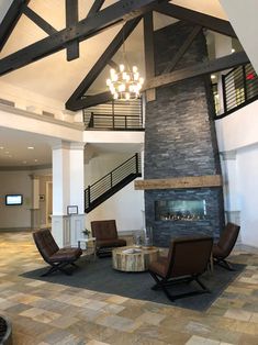 a living room filled with furniture and a fire place in the middle of a building