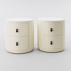 two white nightstands with black handles on each side