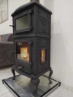 a black stove sitting on top of a wooden floor