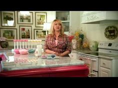 a woman standing in a kitchen next to an oven