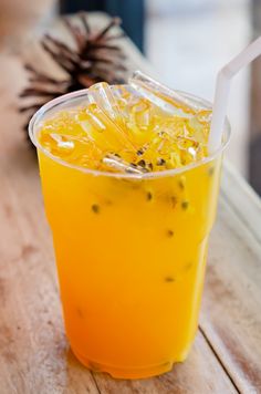 a drink in a plastic cup on a wooden table