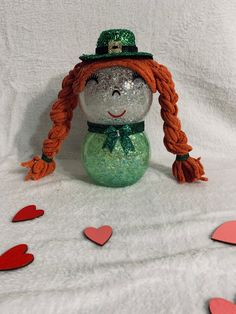 "Handcrafted glass lighted Girl Leprechaun.  Made out of glass bubble vases.  LED fairy lights will illuminate the body of the character.  Lights have 8 different modes, brightness adjustment. and timer.  The battery pack is accessible from behind the character to allow battery replacement.  Remote for lights and batteries are included.  Approx 9\" x 4\"." Diy Decorations Birthday, Girl Leprechaun, Fishbowl Craft, Fish Bowl Crafts, Bubble Vases, Dollar Tree Diy Home Decor, Dollar Tree Easter Crafts, Light Girls, Bowl Ideas