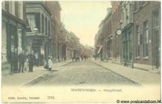 an old postcard shows people walking down the street