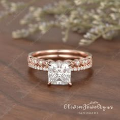 a princess cut diamond ring with pave diamonds on the band