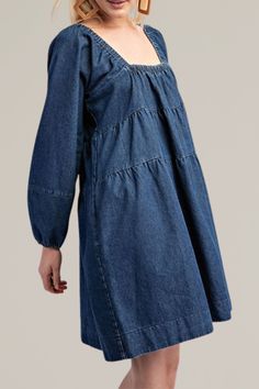 this classic, tiered denim long sleeve dress is crafted from soft, high-quality cotton. it features a flattering square neckline and long sleeves with gathered cuffs for a relaxed yet timeless look. the tiered design adds a playful touch, creating a flowy silhouette that's perfect for any occasion. with practical side pockets, this dress combines comfort and fashion seamlessly. dress it up with statement jewelry or keep it casual with your favorite sneakers for a versatile wardrobe staple. 100% Cotton Long Sleeve Puff Sleeve Dress For Spring, Long Sleeve Cotton Puff Sleeve Dress For Spring, Cotton Puff Sleeve Long Sleeve Dress For Spring, Casual Cotton Puff Sleeve Dress For Fall, Relaxed Fit Puff Sleeve Dresses For Fall, Fall Dresses With Puff Sleeves In Relaxed Fit, Fall Relaxed Fit Dresses With Puff Sleeves, Fall Dress With Puff Sleeves And Relaxed Fit, Long Sleeve Cotton Denim Dress