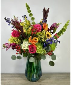 a vase filled with lots of colorful flowers