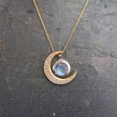 "This unique crescent moon phase pendant is available in silver or 14 k gold. So beautiful polished but equally stunning hand-finished matte, hammered or have it encrusted with diamonds. A focal piece that can be stacked with smaller pendants. It's a slide providing space for a pendant to fit into the opening. We've paired it with our bezel set moonstone. crescent moon 24 millimeters long x 19 mm wide or/ almost 1\" long x 3/4\" wide 14k solid gold or sterling silver pave Diamond encrusted Cresc White Gold Moon-shaped Moonstone Jewelry, Moon-shaped Moonstone Jewelry In White Gold, Celestial Moon Phase White Gold Jewelry, Celestial White Gold Moon Phase Jewelry, Celestial Crescent Jewelry In White Gold, Celestial Crescent White Gold Jewelry, Celestial Crescent Gemstone Jewelry, Celestial Half Moon Jewelry For Anniversary, Celestial White Gold Jewelry With Moon Charm