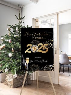 a black and gold new year's eve party sign next to a christmas tree