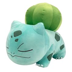 a blue stuffed animal laying next to a green ball