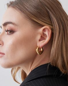 Smaller size huggie hoop earrings that fits snuggly around the ear. This luxury hoop is made 18K gold plated over sterling silver. Modern and sleek design with every single piece hand polished to perfection. Each pair of earrings are produce using our exclusive Italian electroforming technology to control the weight to maximize comfort. This design is available in 2 colors, 18k yellow gold or white gold. Closure: Hoop Stamp Closure Approx. Measurement: Outer Length: 1.1 inches Outer Width: 1 inc Luxury Yellow Gold Modern Huggie Earrings, Modern Pierced Huggie Earrings, Modern Small Hoop Huggie Earrings For Pierced Ears, Modern Gold Huggie Hoop Earrings, Modern Huggie Hoop Earrings, Modern Gold Plated Huggie Earrings, Modern Everyday Huggie Earrings, Modern Teardrop Single Huggie Earring, Modern Hypoallergenic Gold Plated Hoop Earrings