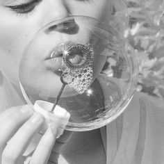 a woman holding a glass ball in her mouth