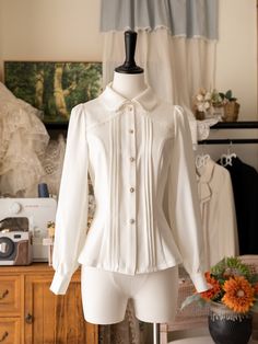 Add a touch of Victorian elegance to your wardrobe with this white long-sleeve shirt featuring a detachable jabot on the neckline. Perfect for adding a sophisticated and gothic twist to your outfit, this versatile piece can be dressed up or down for any occasion.  This price includes a shirt and a detachable jabot.   	 		 			Size 			S 			M 			L 			XL 			2XL 		 		 			Shoulders 			38 			39.5 			41 			42.5 			44 		 		 			Bust 			86 			92 			98 			104 			110 		 		 			Waist 			68 			74 			80 			86 Elegant Shirt With Fitted Ruffled Collar, Elegant Fitted Shirt With Ruffled Collar, Fitted White Shirt With Ruffled Collar, White Fitted Shirt With Ruffled Collar, White Formal Shirt With Ruffled Collar, Fitted Blouse With Detachable Collar For Workwear, Elegant White Shirt With Ruffled Collar, Elegant Peter Pan Collar Shirt For Fall, Classic Fitted Shirt With Peter Pan Collar