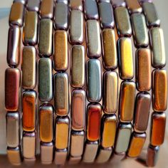 a close up of a bracelet made out of different colored beads