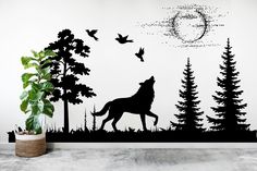 a wall decal with a wolf and birds in the forest