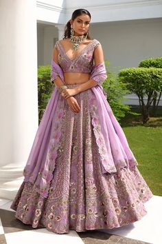 Lavender A-line flare lehenga, accentuated with all over sequin, cutdana, beads and crystal embellishments in floral bloom pattern. Paired with a plunging V neckline blouse, highlighted with all over floral bloom embroidery in sequin embellishments. Comes with a scallop trim cutwork dupatta.
Component: 3
Pattern: Hand Embroidered
Type Of Work: Sequin,Flower,Cutdana,Beads,Crystals
Neckline: Plunging V Neck
Sleeve Type: Sleeveless
Fabric: Silk, Satin Organza
Color: Purple
Other Details: 
Four side Purple Lehenga Bridal, Engagement Dress For Bride Indian, V Neckline Blouse, Flare Lehenga, Lavender Lehenga, Engagement Dress For Bride, Purple Lehenga, Heavy Lehenga, Chic Prom Dresses