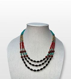 Step into the world of boho chic with our Bohemian Dreams Handcrafted Beaded Multi-Strand Necklace, a perfect blend of free-spirited style and elegance. Features: Intricate Beadwork: Black, red, turquoise, and golden beads are thoughtfully arranged to create a vibrant, captivating design. Adjustable Length: The necklace features an adjustable hook clasp, allowing you to customize the length for any outfit or occasion. Versatile Style: Ideal for both casual and formal wear, this statement piece complements a wide range of looks. Artisan Craftsmanship: Handcrafted by skilled artisans, each necklace is a testament to their dedication and attention to detail. Size & Material: Material: High-quality beads with a sturdy link chain Style: Multi-strand, adjustable length Care Instructions: Store i Bohemian Adjustable Beaded Necklace With Black Beads, Adjustable Bohemian Beaded Necklace With Black Beads, Bohemian Black Beads Jewelry, Turquoise Beaded Necklaces With Black Beads For Festival, Bohemian Faceted Beads For Festival, Bohemian Faceted Beads Necklace For Festival, Bohemian Beads For Jewelry Making And Festivals, Handmade Bohemian Beaded Necklaces For Festive Occasions, Handmade Bohemian Beaded Necklace For Festive Occasions