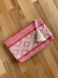 "In Santo Tomás Jalieza, Oaxaca, Mexico, a collective of more than 100 women is responsible for generating a large part of their town's economy. Using the backstrap weaving technique (telar de cintura), they create large pieces of loomed fabric to cut and assemble different articles later.  Pink with White clutch from Santo Tomás Jalieza, Oaxaca, Mexico  Height: 6\", Length: 9.5\" Take home this beautiful clutch, can be used as cosmetic bag! We support Latin artisans through fair trade, empowering them, and promoting admiration and love for our culture. Thank you for being a part of it." Traditional Handmade Beach Clutch, Bohemian Pouch Coin Purse, Bohemian Woven Pouch For Gift, Bohemian Style Pouch Coin Purse For Everyday, Bohemian Coin Purse For Everyday Use, Rectangular Woven Clutch For Festival, Woven Pouch Clutch As Gift, Bohemian Beige Clutch Pouch, Beige Bohemian Clutch Pouch