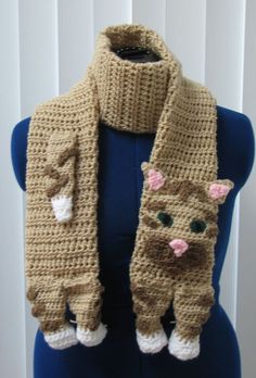 a crocheted cat scarf on a mannequin