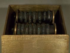 a wooden box filled with lots of metal objects