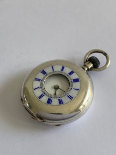 ANTIQUE Ladies Solid Silver Half Hunter Victorian Fob Pocket Watch. Hallmarked 900 Continental Silver. Ref no. 370 Beautiful half hunter case with white enamel chapter ring to outer case with blue roman numerals. Inner white enamel dial having black roman numerals & blue steel hands. Mechanical Swiss movement. Bow wound. Watch dimensions - 24mm diameter. Height inc. bow 37mm. This watch is sold with a 12 month guarantee from MBHI certificated watchmakers, established 1947. All watches will be serviced before shipping hence the 2-3 week dispatch. Please note - Watches are not waterproof unless otherwise stated and it is recommended not to wear them near water (i.e. washing hands, washing up, shower, swimming etc). Antique Collectible Watch With Polished Finish, Antique Collectible Watches With Polished Finish, Vintage Silver Pocket Watch With Round Dial, Antique Watch Accessories With Polished Finish, Antique Chronometer Watch Accessories, Vintage Silver Watch Accessories With Polished Finish, Antique Silver Watches With Subdials, Antique Silver Watch With Round Dial, Collectible Silver Pocket Watch With Round Dial