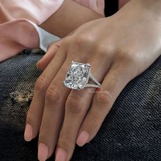 a woman's hand with a diamond ring on it