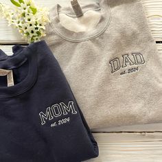 best gifts for mom, baby announcement, gift for grandma, christmas gift, mothers day, gift for mom, mom sweatshirt, mama sweatshirt, grandma sweatshirt, embroidered gift, new mom PRODUCT AND BRAND DETAILS ➤ Gildan ® brand ➤ Unisex & Classic fit ➤ 8 oz./yd² (US) 13.3 oz./L yd (CA), 50/50 cotton/polyester, 20 singles - Heather Sport colors are 60/40 polyester/cotton PERSONALIZED GUIDE: Custom sweatshirts, hoodies, and tees will usually have four embroidery positions: ➤On the chest: Left chest (above the heart), right chest, middle chest. ➤On the sleeve: Left sleeve or right sleeve (you can customize both, one side is free). ➤On the back of the shirt: In the middle. ➤In the hood for hoodies. If you want to embroider any of these positions, please place an order and let us know in the Personal Gift For New Dad, Custom Embroidered Sweatshirt, Mom Dad Baby, New Dad Gift, Best Gifts For Mom, Embroidered Gifts, Mama Shirts, Gifts For New Dads, Mama Sweatshirt