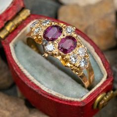 This beautiful ring features two oval cut rhodolite garnets and single cut diamond accents. The garnets show chips and abrasion but it's not overly noticeable without a very close look. This ring is crafted of 15k yellow gold with English hallmarks and is currently a size 6.5. Oval Cut Ring Modern, Oval Ruby Rings With Single Cut Diamonds, What Every Girl Needs, Garnet And Diamond Ring, Oval Cut Ring, Ad Hoc, Rings Collection, Gemstones Jewelry, Girl Needs