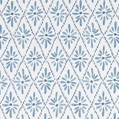 a blue and white wallpaper pattern with small flowers on the left side of it