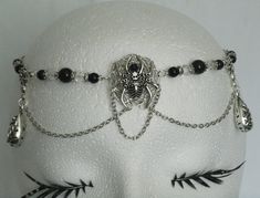 "Spider Circlet This beautiful beaded circlet has clear faceted glass beads, black glass beads, pewter silver accent drops, sterling silver plated chain, sterling silver plated spiderweb and pewter silver spider with rhinestone. 20\" long can be adjusted to 24\" long. Lobster clasp." Gothic Nickel-free Silver Body Jewelry, Nickel-free Gothic Silver Body Jewelry, Nickel-free Silver Gothic Body Jewelry, Gothic Silver Jewelry For Costume Party, Silver Fantasy Costume Jewelry, Adjustable Silver Gothic Body Jewelry, Black Fantasy Jewelry For Costume, Gothic Adjustable Body Jewelry For Festivals, Black Fantasy Costume Jewelry