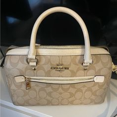 Coach Bag In Good Used Condition. Some Minor Marks / Signs Of Wear Shown In Photos. Original Price Of Bag $385. The Going Rate For This Bag Is About $150-300 I Am Open To Offers! This Bag Is A Light Brown/Tan/Beige Cream Color With White/Off White Accents. With The Classic Coach “C” Logo All Around. White Coach Bag, Coach Bag, White Accents, Coach Bags, Cream Color, Light Brown, Satchel, Bag Lady, Off White