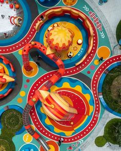 an overhead view of a play area with toys on the ground and in circles around it