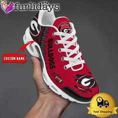 a hand holding up a red and white shoe with the word florida on it's side