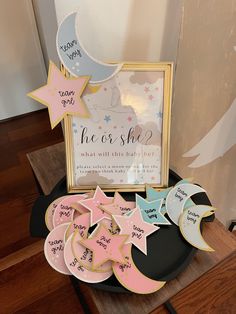 a table topped with cookies next to a sign and some stars on top of it