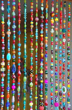 colorful beads hanging from the ceiling in a room