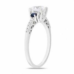 A dazzling look with an unexpected pop of color, this fashion ring will take her breath away. Beautifully crafted in cool 10K white gold, the eye is drawn to the 6.5mm lab-created white sapphire center stone standing tall in a traditional four-prong setting. Smaller lab-created blue sapphires flank this center stone, while 1/10 ct. t.w. of shimmering diamonds line the ring's shank. An elegant look she's certain to adore, this ring is finished with a bright polished shine. Timeless White Sterling Silver Diamond Ring, White Diamond Ring With Accents In Sterling Silver, White Solitaire Jewelry In 14k White Gold, White Solitaire 14k White Gold Jewelry, Sterling Silver White Diamond Ring With Accents, White Sterling Silver Diamond Ring With Accents, Luxury Rings With Lab-created Sapphire And Prong Setting, White Solitaire Diamond Ring In Sterling Silver, Luxury Sterling Silver Birthstone Ring With Prong Setting