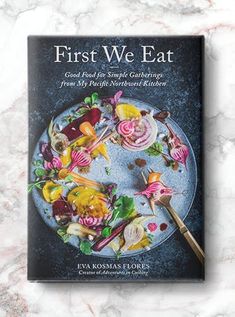 the first we eat cookbook sits on a marble surface