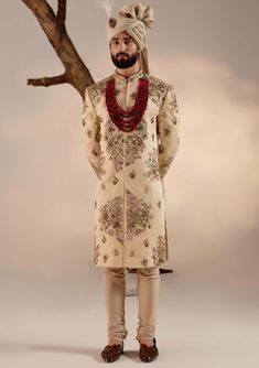 Editor's Note Featuring our work of art in our golden placement hand-embroidered sherwani with an intricate embroidery technique using different types of dabka and moti. Paired with a wine hand-embroidered stole and matching safa. Fabric: Linen silk Color: Golden Components: Sherwani, kurta, churidar, stole and safa Occasion: Groom Fit: Regular Note: Product colour may slightly vary due to photographic lighting sources Care: Dry clean only About the Designer After establishing himself as the lea Reception Bandhgala With Zari Work, Naqshi Embroidered Straight Sherwani For Reception, Naqshi Embroidered Sherwani For Reception, Naqshi Embroidered Straight Kurta Sherwani For Reception, Unstitched Sherwani For Reception, Traditional Jamawar Churidar With Naqshi Detailing, Jamawar Churidar With Naqshi And Traditional Drape, Sherwani For Reception With Resham Embroidery And Straight Kurta, Traditional Churidar With Gold Embroidery For Designer Wear