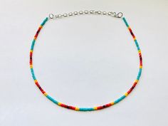 This sunset themed boho necklace is made with  turquoise, yellow, orange, and red glass seed beads to create a cool sunset effect.  It comes in four different lengths (14, 16, 18, or 20 inches) and each necklace also comes with three additional inches of extender chain.  This summer necklace brings out the beach vibes all year round! Get yours today for yourself or as a gift for a friend or family member! Adjustable Turquoise Necklace With Colorful Beads For Festival, Bohemian Yellow Single Strand Beaded Necklace, Yellow Bohemian Single Strand Beaded Necklace, Orange Necklaces With Spacer Beads For The Beach, Colorful Beaded Hippie Jewelry, Multicolor Spacer Beads Jewelry For Summer, Handmade Turquoise Necklace For Summer, Orange Beach Necklace With Spacer Beads, Orange Necklace With Spacer Beads For Beach