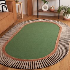 a living room area with a rug, couch and coffee table on the floor in front of it