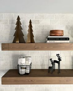 two shelves with christmas decorations and books on them